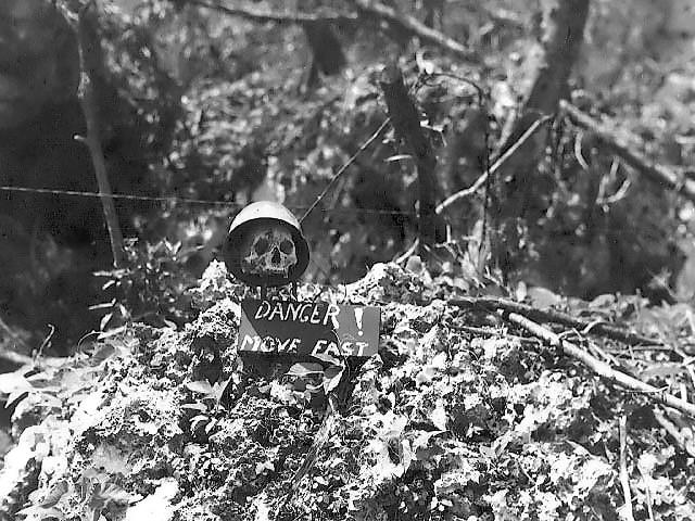 Front line warning sign using a Japanese soldier's skull on Peleliu